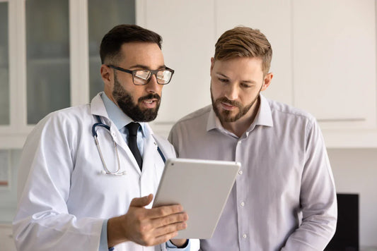 Man looking at Sperm Test results with Doctor