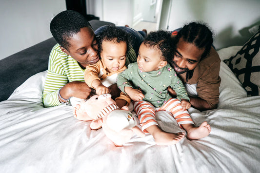 A woman and man with two children playing in their home