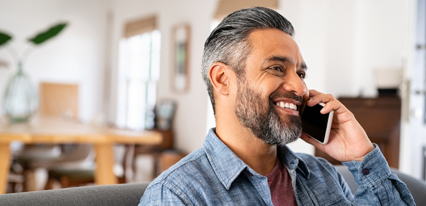 Man smiling while on the phone