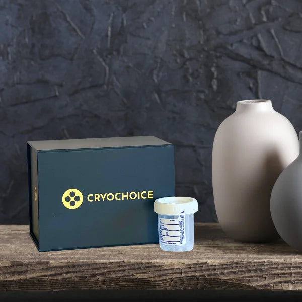 Image shows CryoChoice's at-home sperm collection kit next to vases on a wood table.