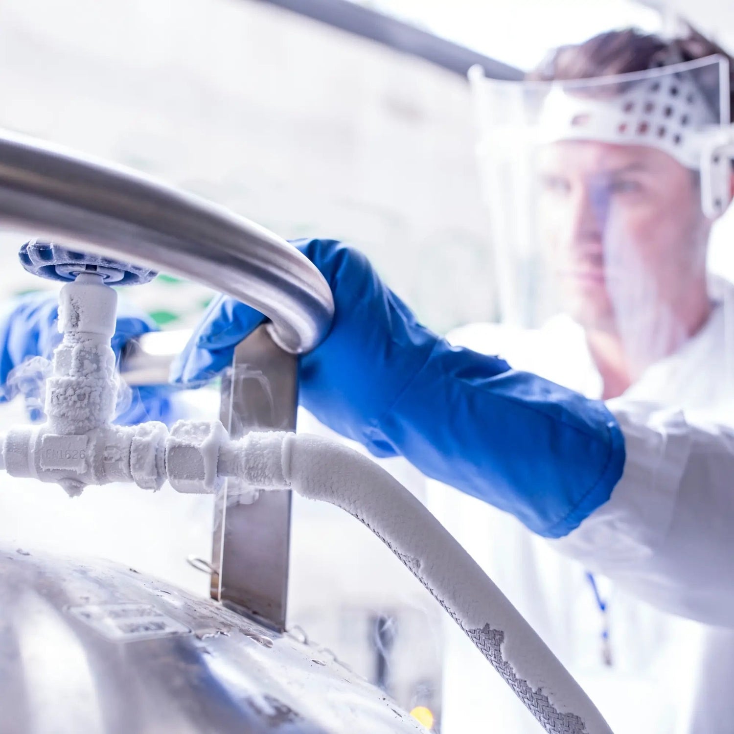 A man is securing a cryopreservation tank to freeze sperm indefinitely.