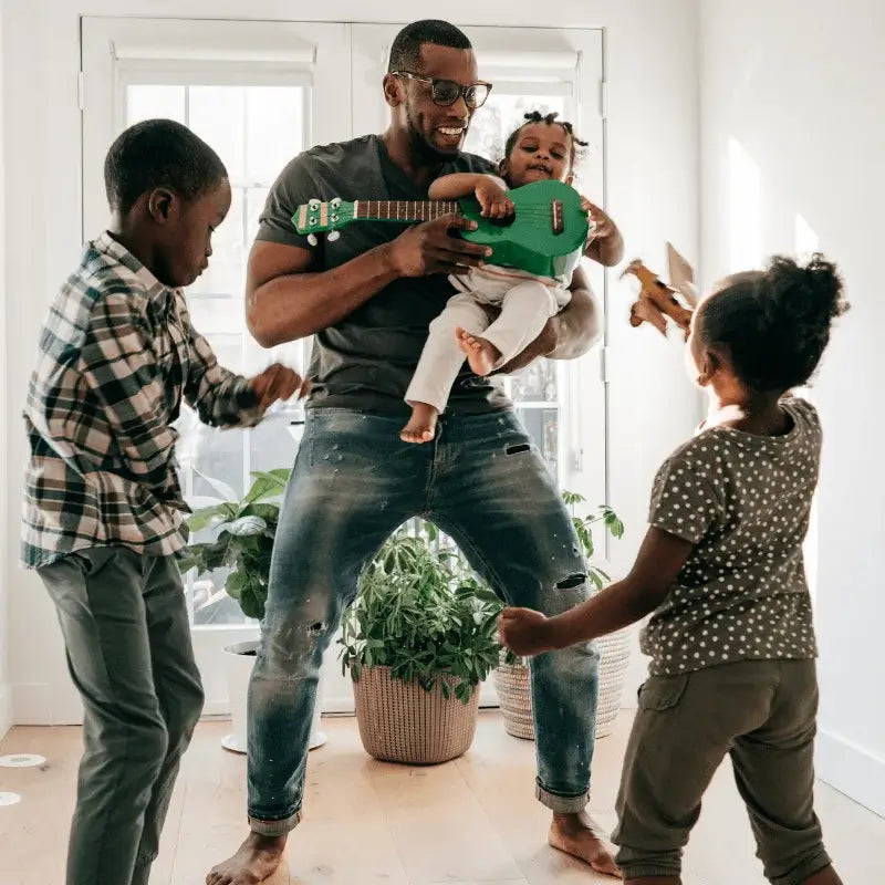 Dad playing with his three kids