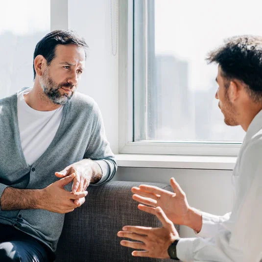 Fertility doctor speaking with patient in a clinic about freezing their sperm.