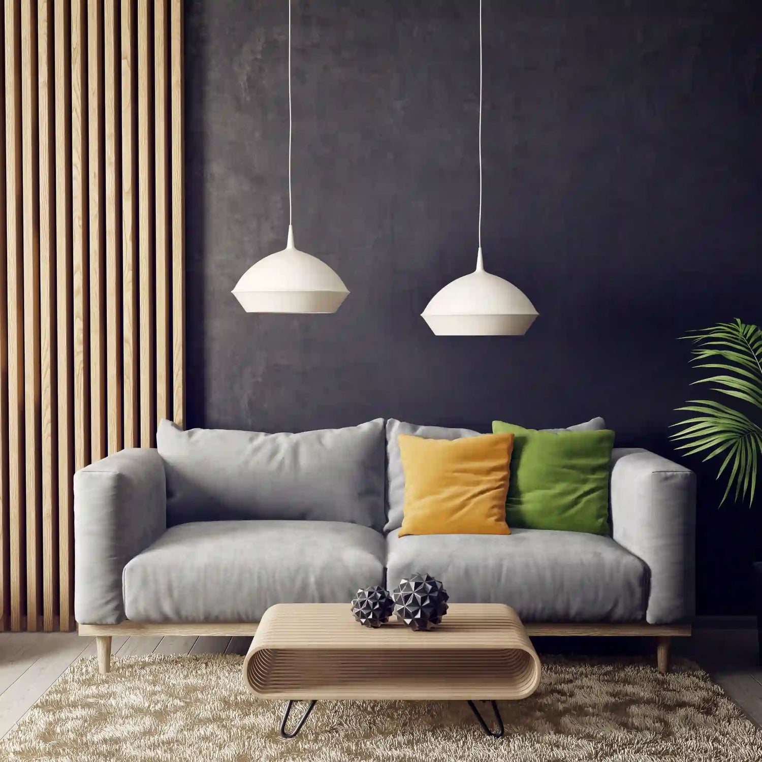 A couch and table in a living room with dark walls and bright yellow and green pillows