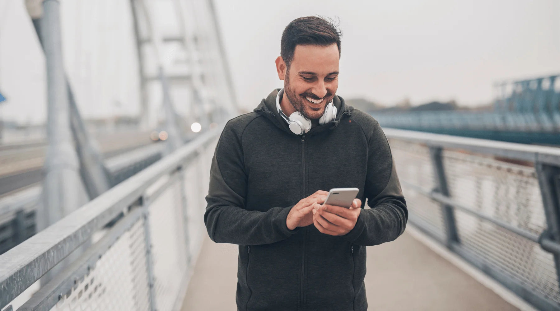 Man looking down at his phone researching at-home sperm freezing options.